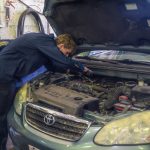 mechanic working under the hood
